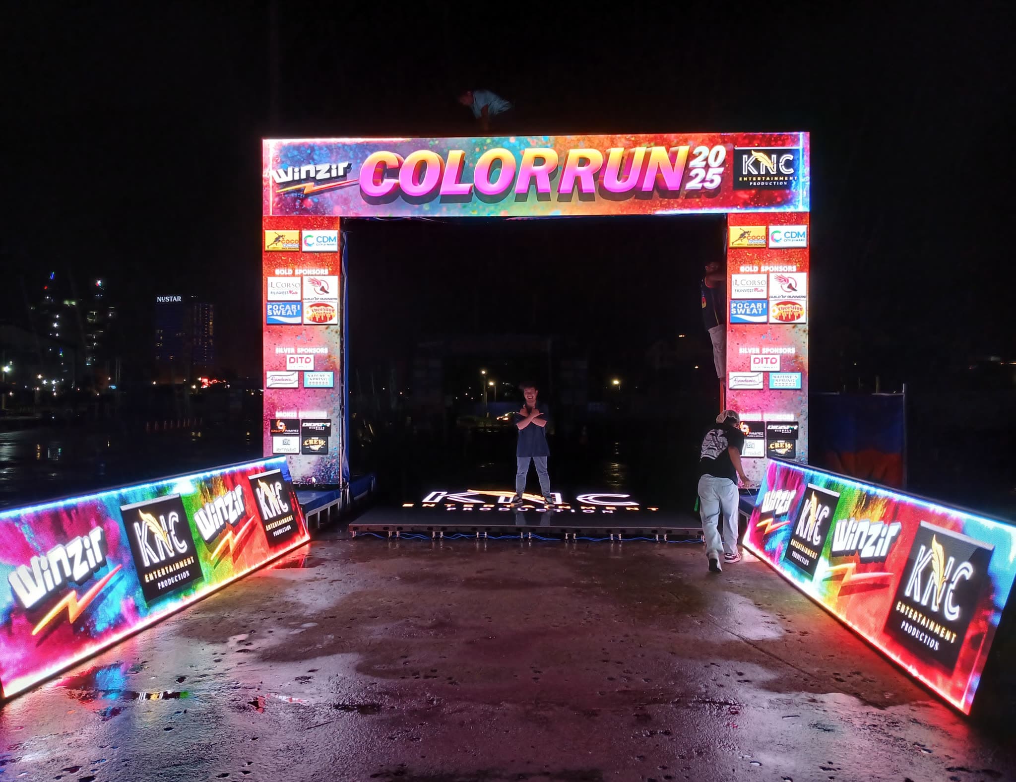 LED start arch and side banners built for a night fun-run, showing sponsor branding
