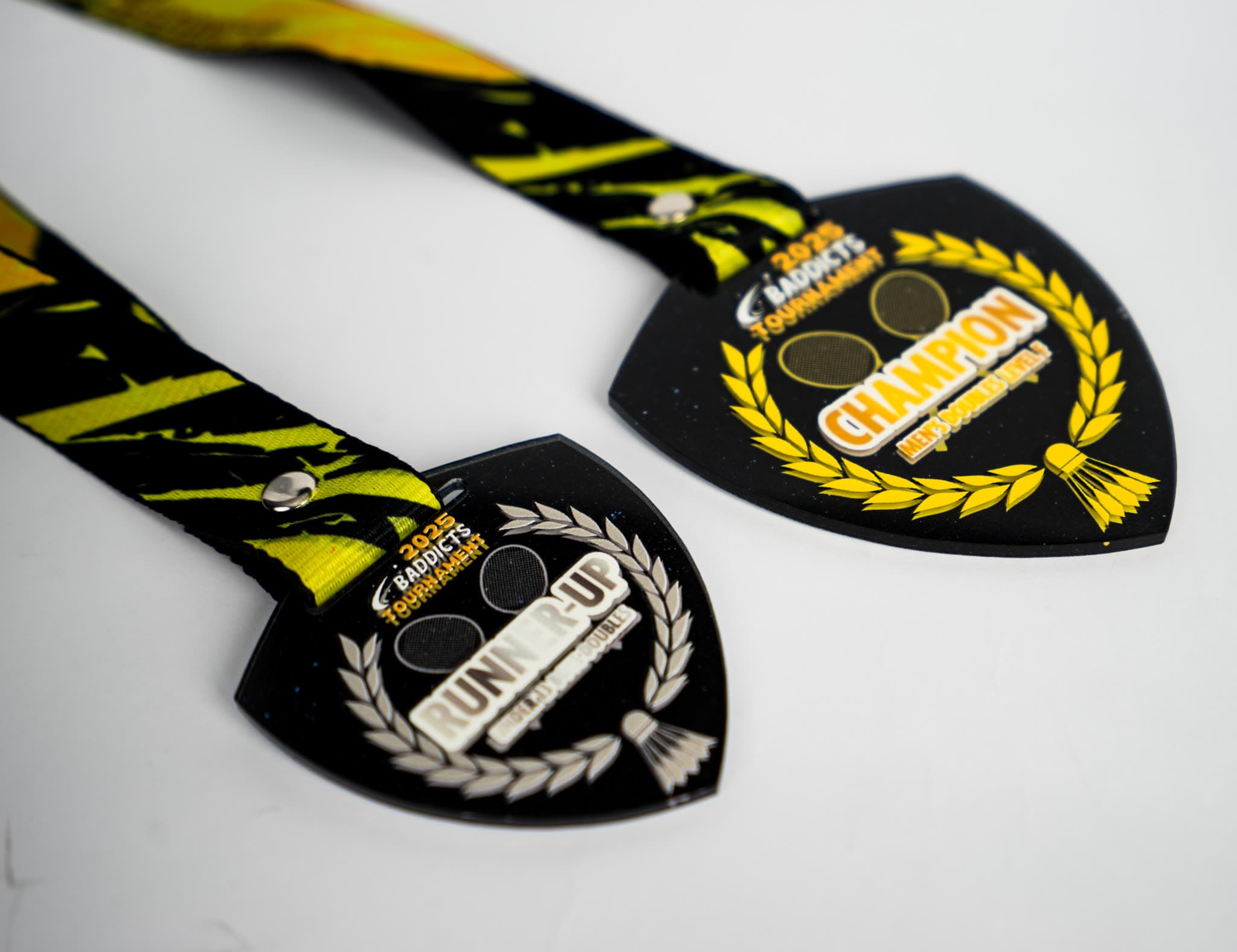 Two custom acrylic tournament medals on printed lanyards, champion and runner-up